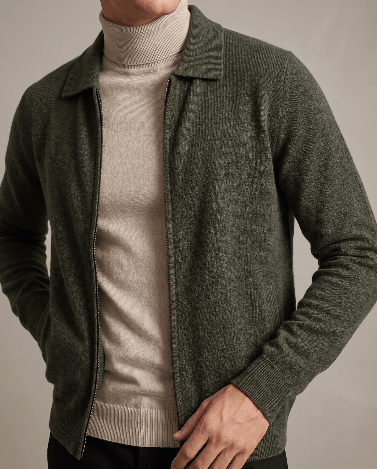 Close-up of the olive green cardigan zipped open over a beige turtleneck