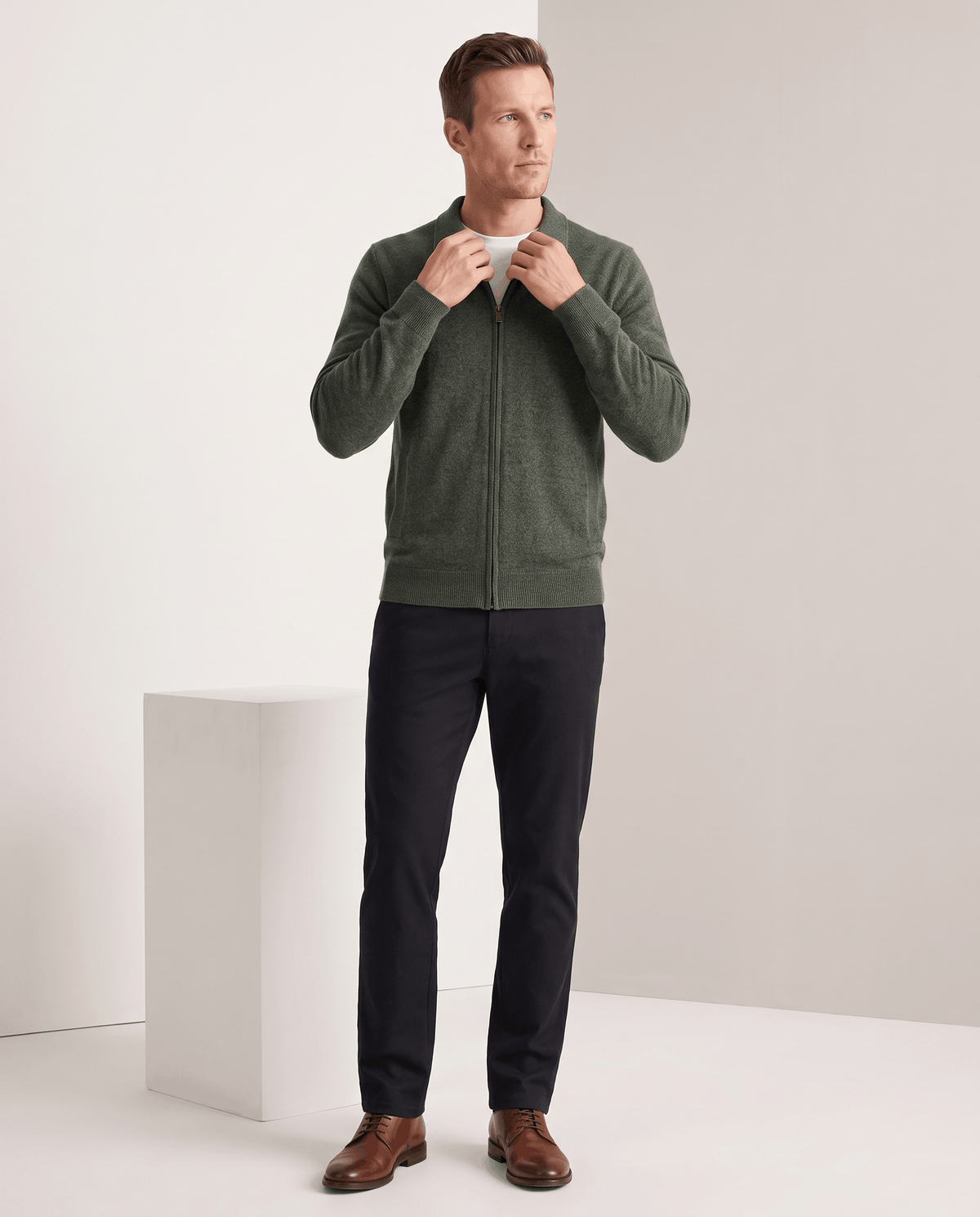 Full-length view of the olive green cardigan with navy trousers and brown shoes