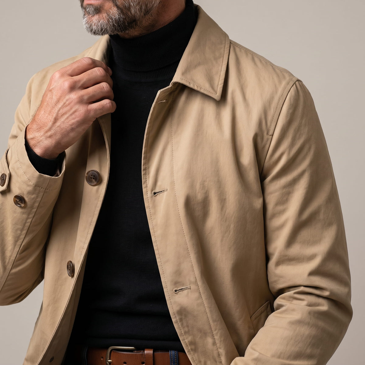 Close-up of the collar and side pocket on a beige trench coat