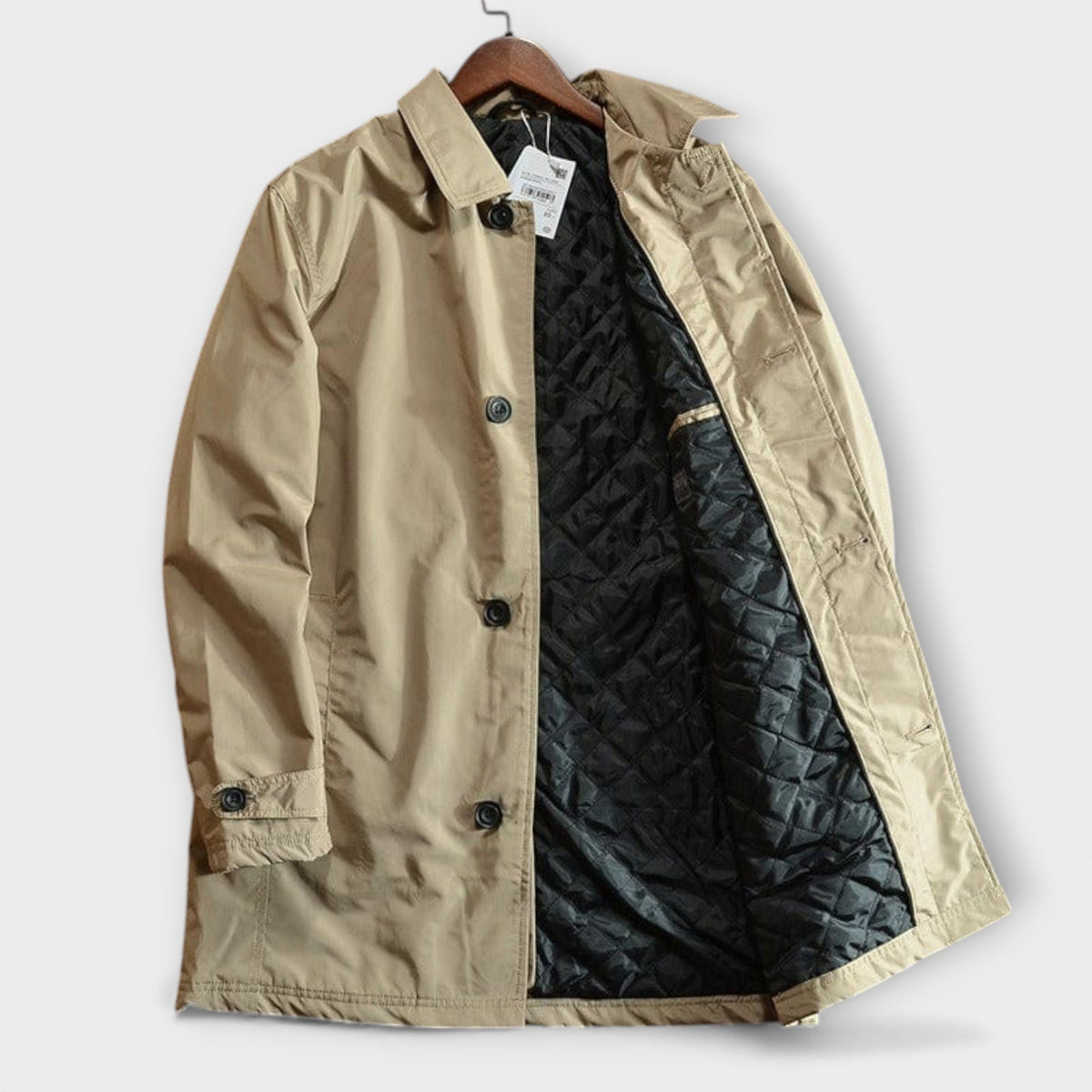 Beige trench coat laid flat and open to show the quilted lining