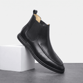 Single black smooth-grain moc toe Chelsea boot with elastic side panels, a pull tab, and a slim cupsole.