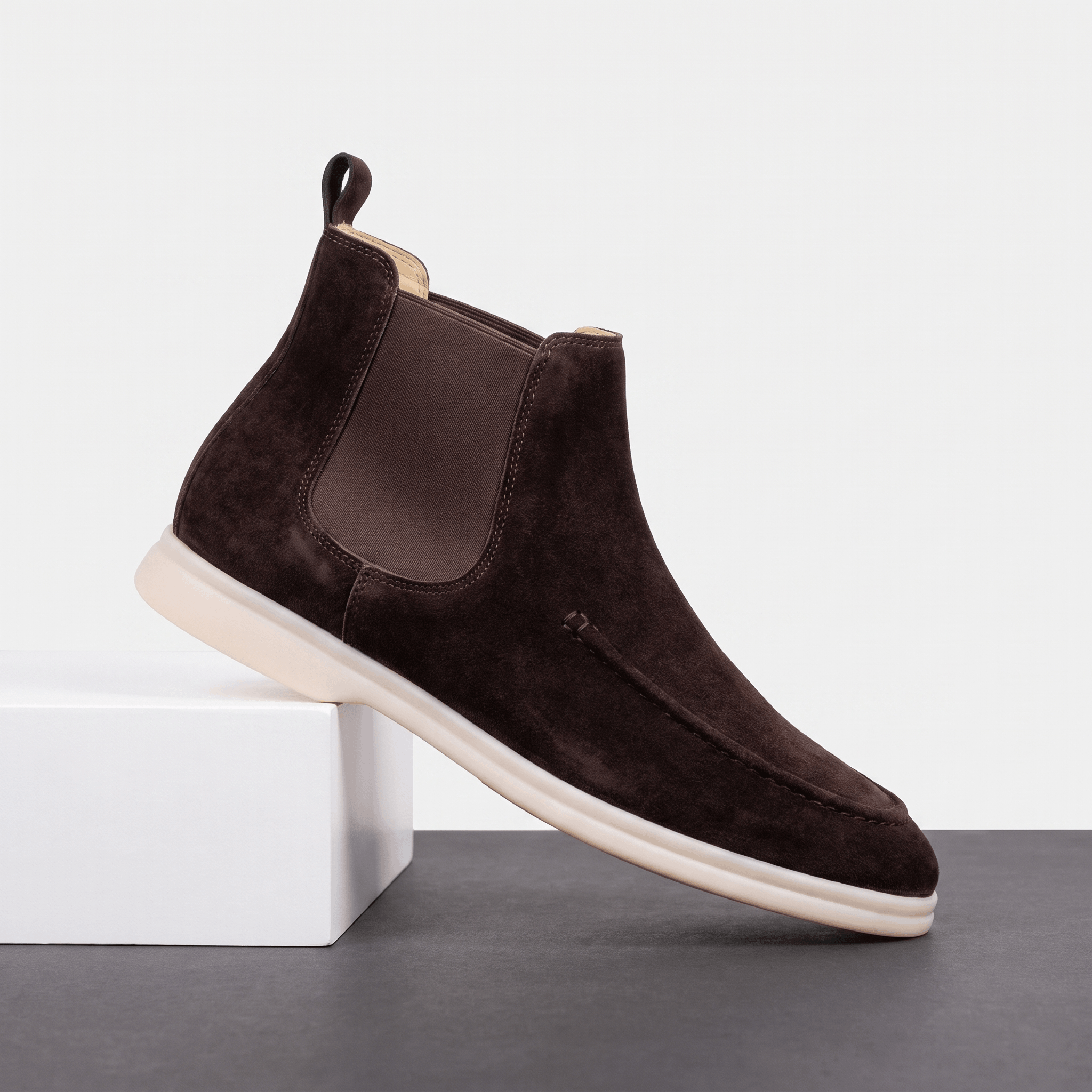Single dark brown suede moc toe Chelsea boot with an elastic side panel and a light cupsole.