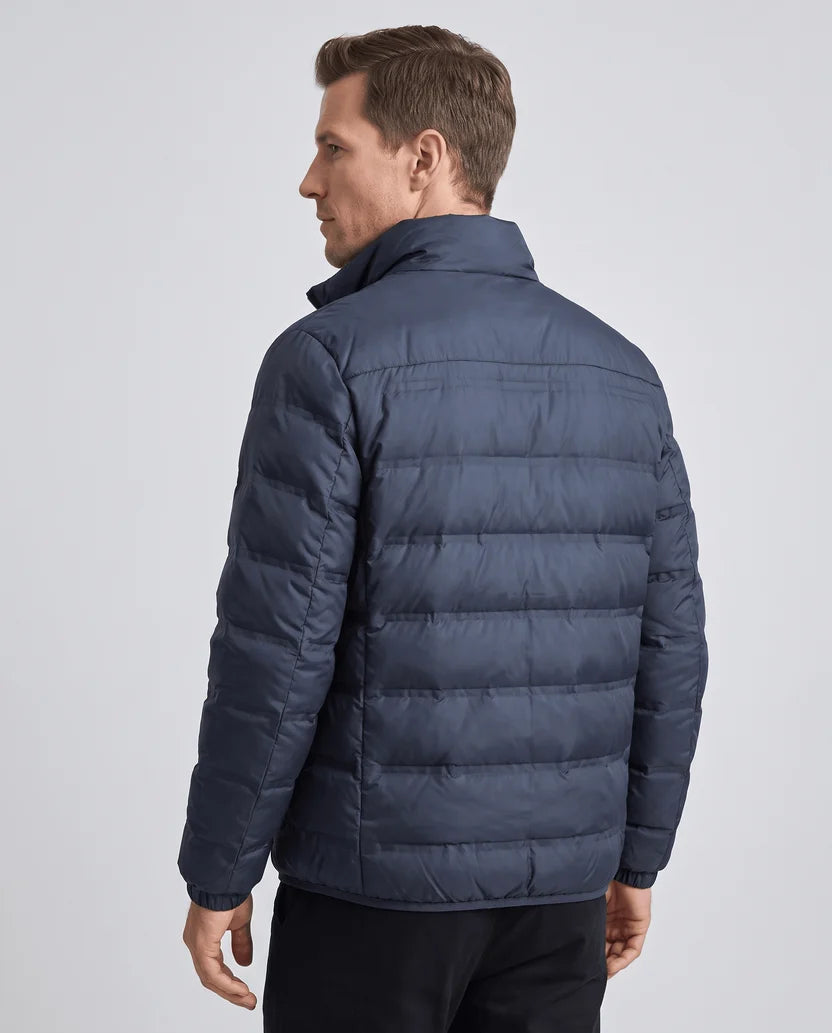Back view of a man wearing a navy blue quilted puffer jacket