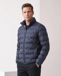 Man wearing a navy blue quilted duck down puffer jacket with stand collar, front view