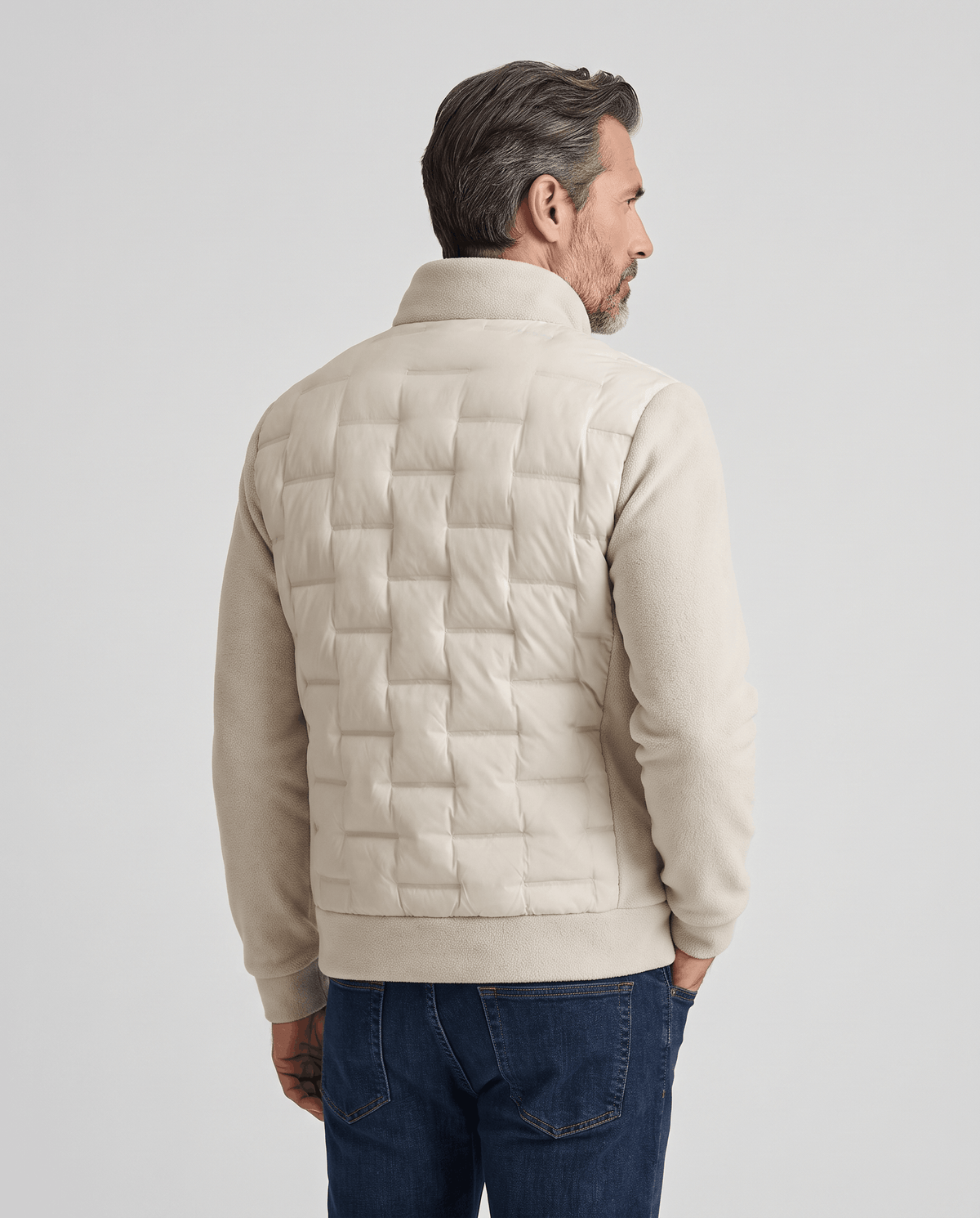 Back view of a man wearing an off-white quilted hybrid puffer jacket