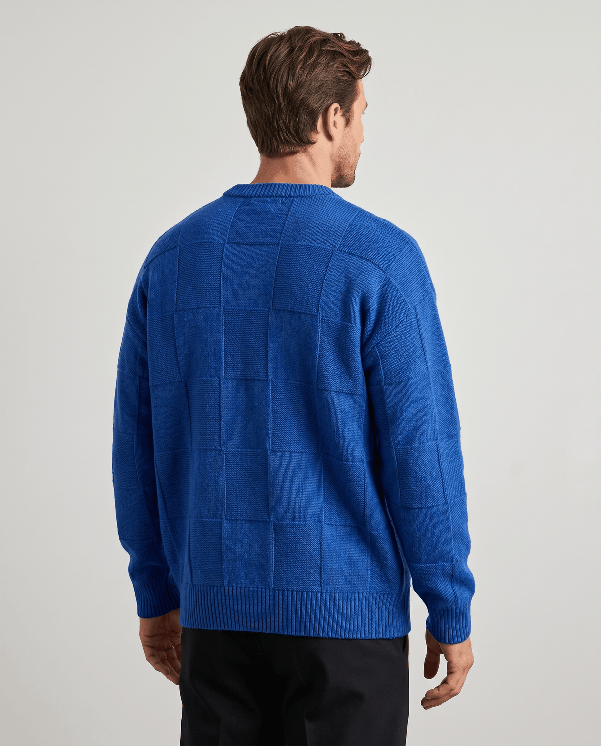Back view of blue oversized knit sweater with dropped shoulders