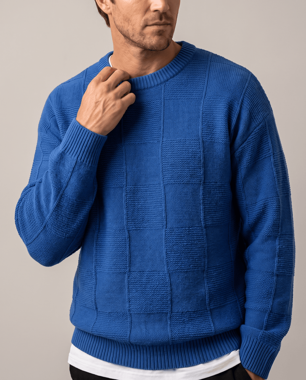 Front close-up of blue tonal checkerboard knit over a white tee