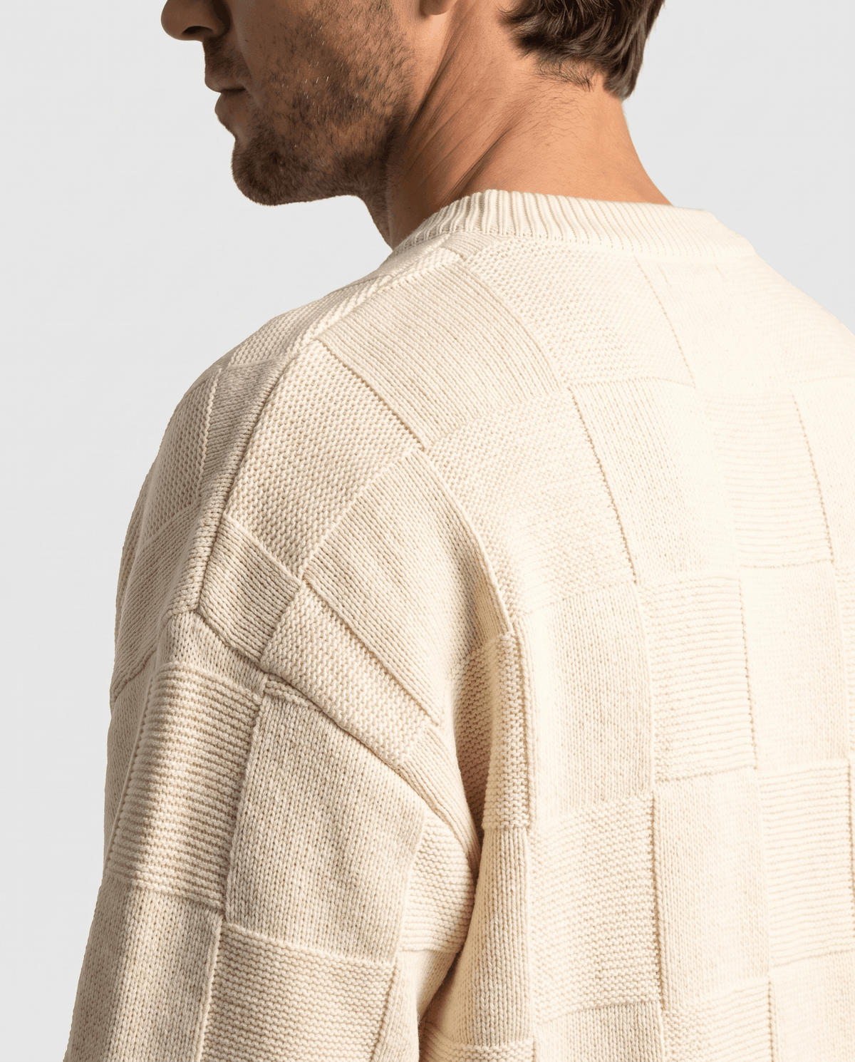 Side view of cream knit collar and dropped shoulder seam