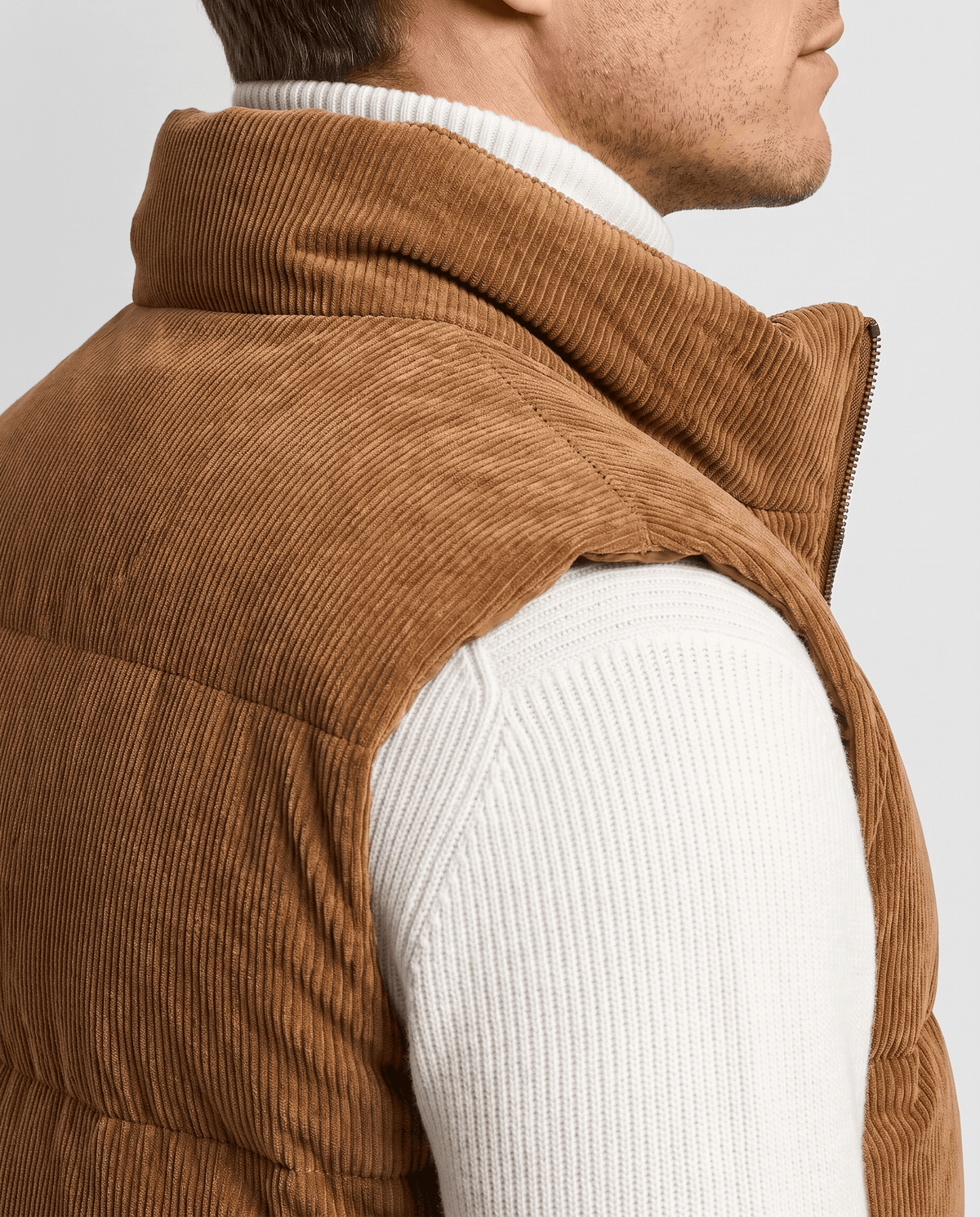 Close-up of brown corduroy vest showing the high stand collar and ribbed texture