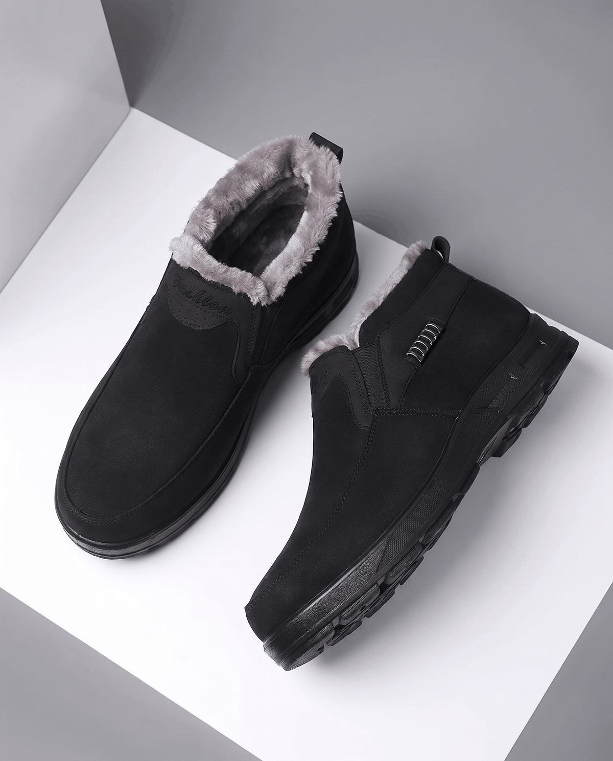 Pair of black fleece-lined ankle boots shown from above on a white background.