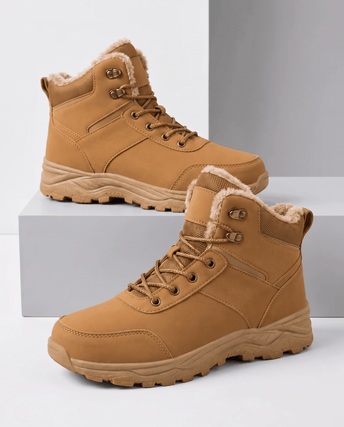 Tan insulated lace-up winter boots with padded collars and rugged lug soles displayed on white blocks.