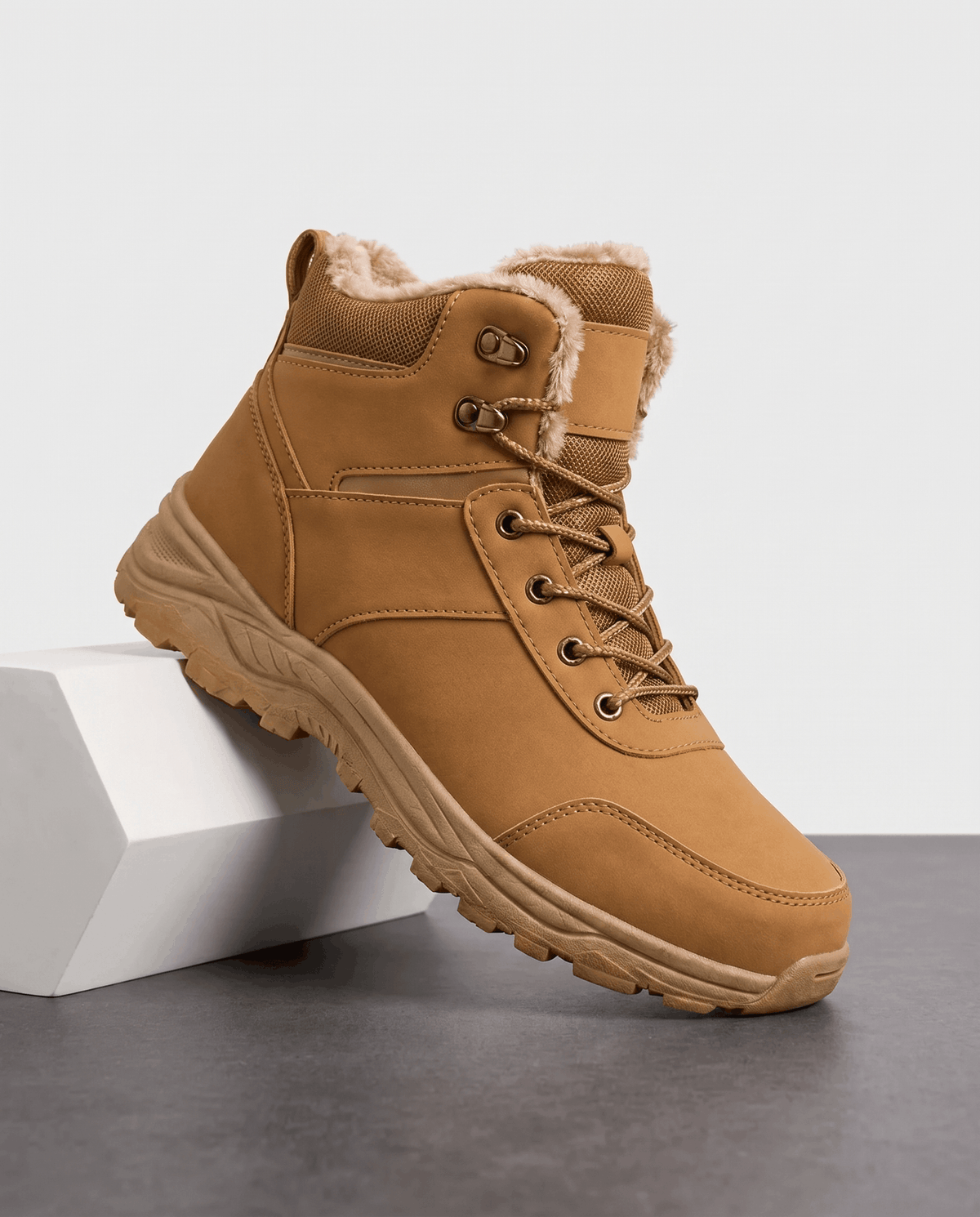Tan insulated lace-up winter boot shown on a white pedestal.