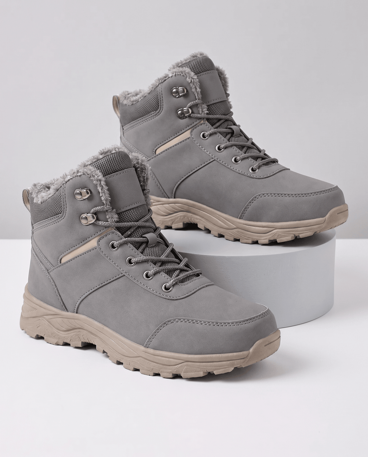 Gray insulated lace-up winter boots displayed on a white background.