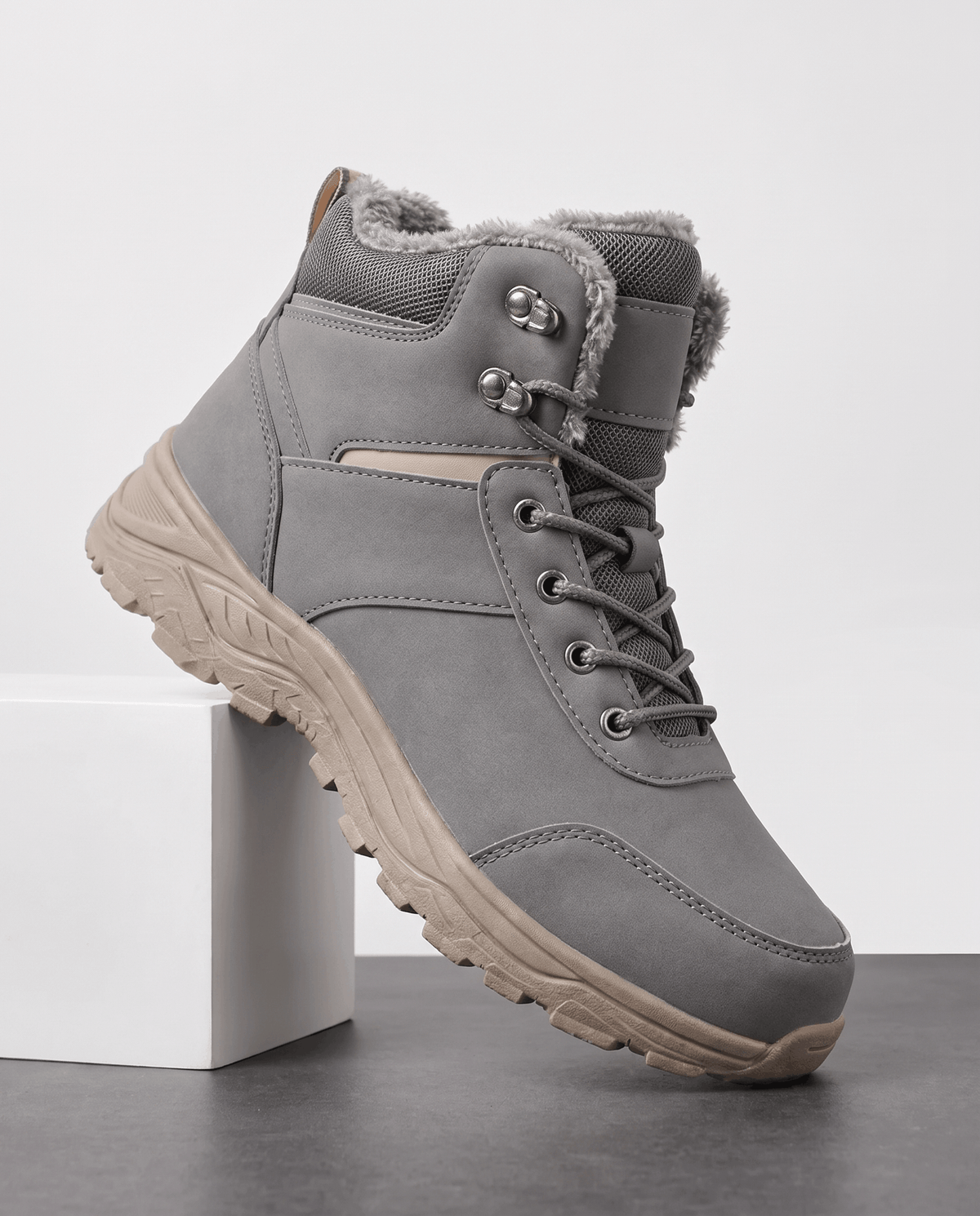 Gray insulated winter boot shown on a white pedestal.
