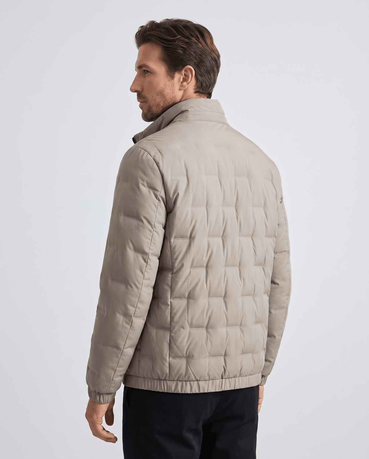 Back view of the beige Sutton quilted down jacket showing square block quilting and elasticated hem