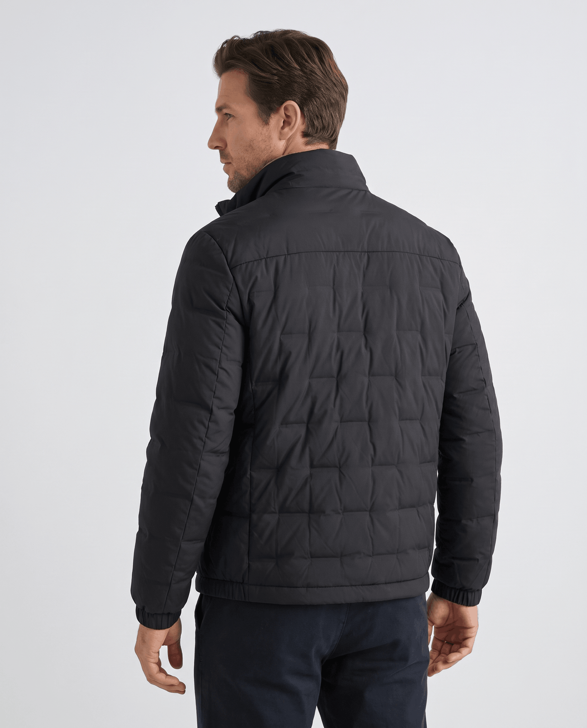 Back view of the black Sutton quilted down jacket showing square block quilting and stand collar