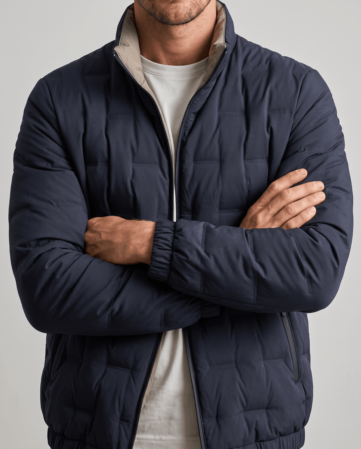 Close-up of the blue Sutton quilted down jacket with beige lining, elasticated cuffs and zip side pocket