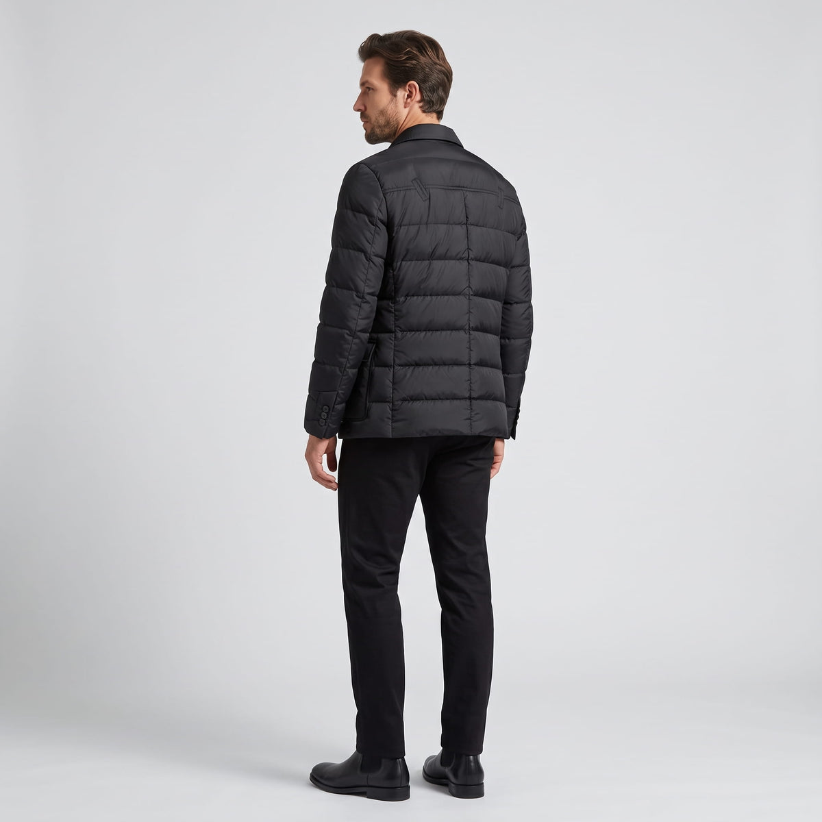 Full back view of the black blazer showing horizontal quilted channels