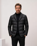 Man wearing black quilted puffer blazer with notch lapels over a turtleneck