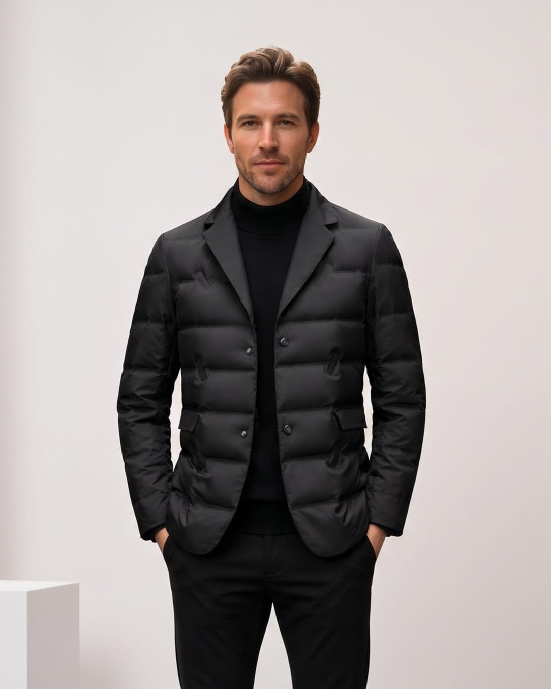 Man wearing black quilted puffer blazer with notch lapels over a turtleneck