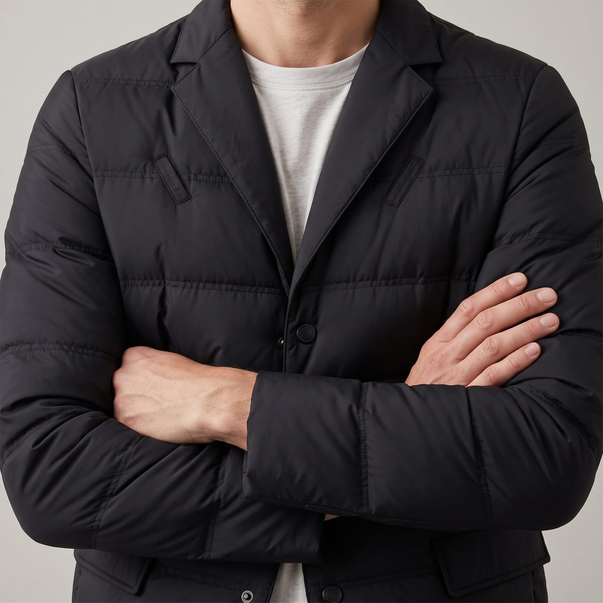 Black blazer torso with arms crossed, lapel roll and quilted sleeve in view