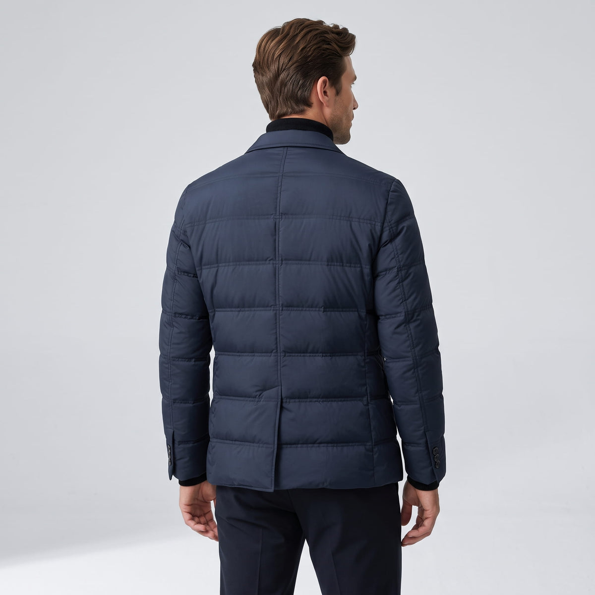 Back view of the navy blazer showing the quilted panels and hip-length hem