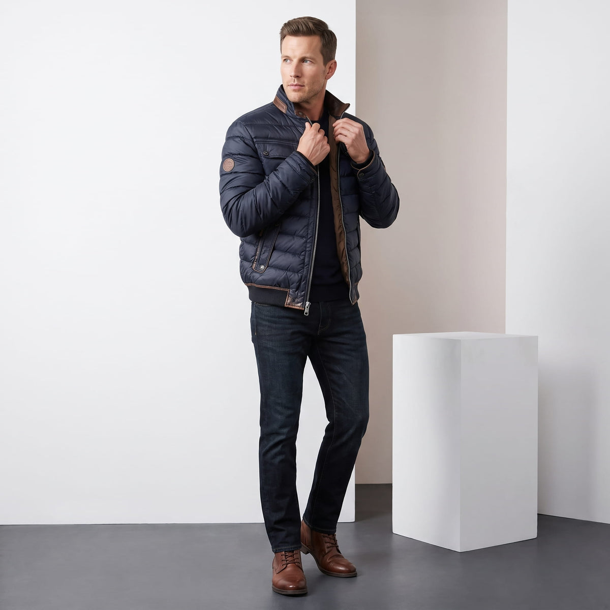 Navy jacket styled full-length with dark jeans and brown leather boots