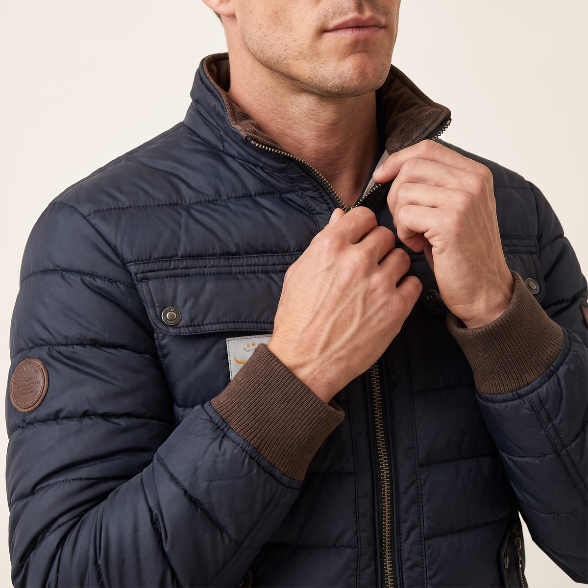 Close view of the tan trim on the collar and cuff, with the front zip half open
