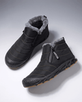 Pair of black insulated ankle boots with cushioned lining displayed on a white surface.