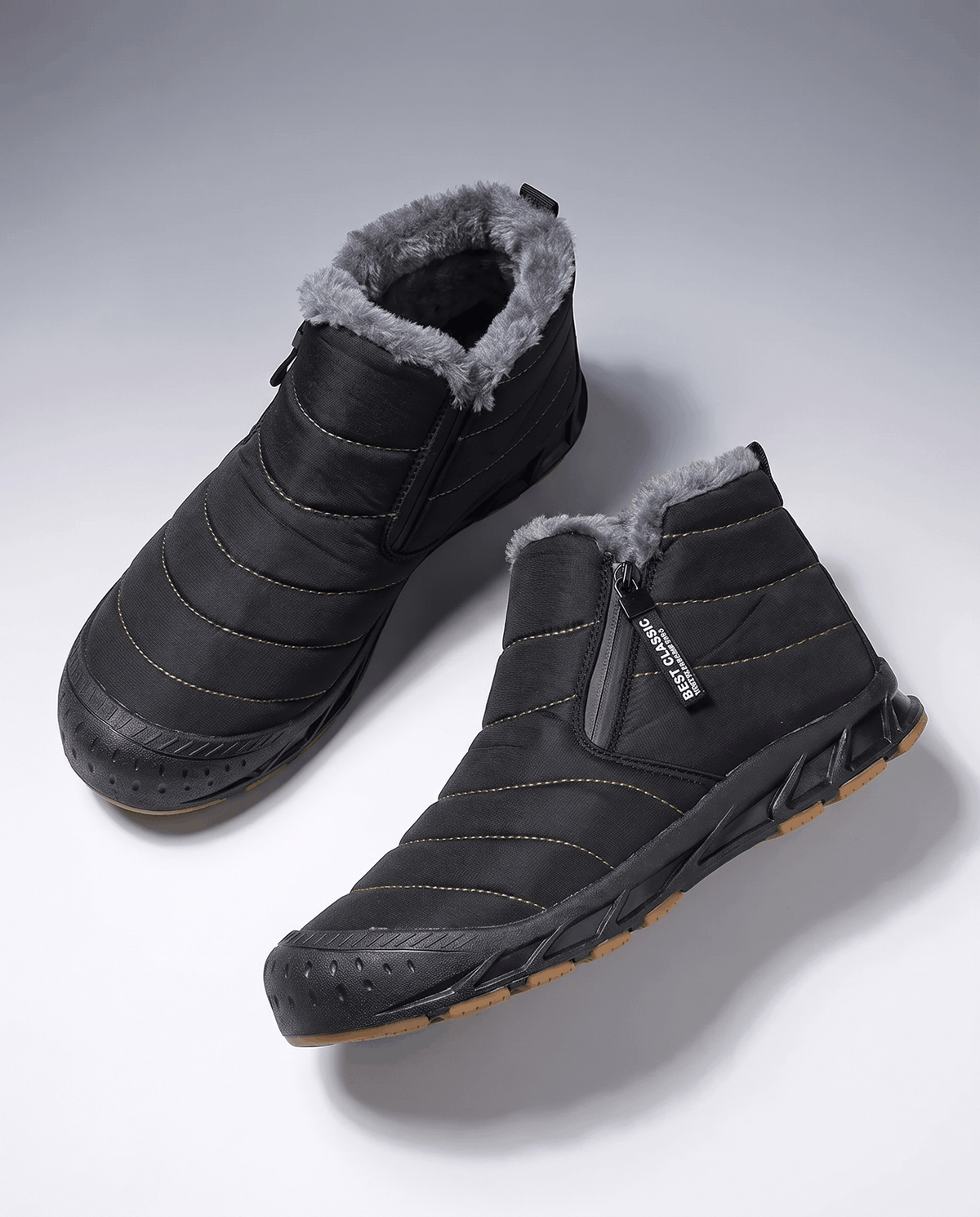 Pair of black insulated ankle boots with cushioned lining displayed on a white surface.