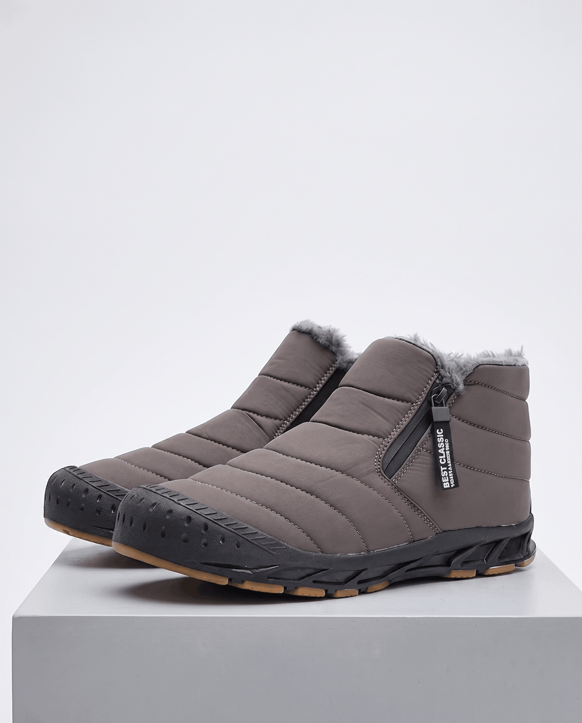Pair of gray insulated ankle boots displayed on a white surface.