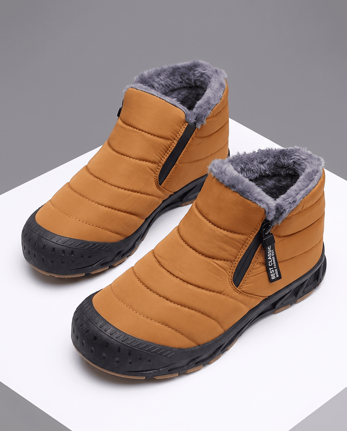 Pair of orange insulated ankle boots shown from above.