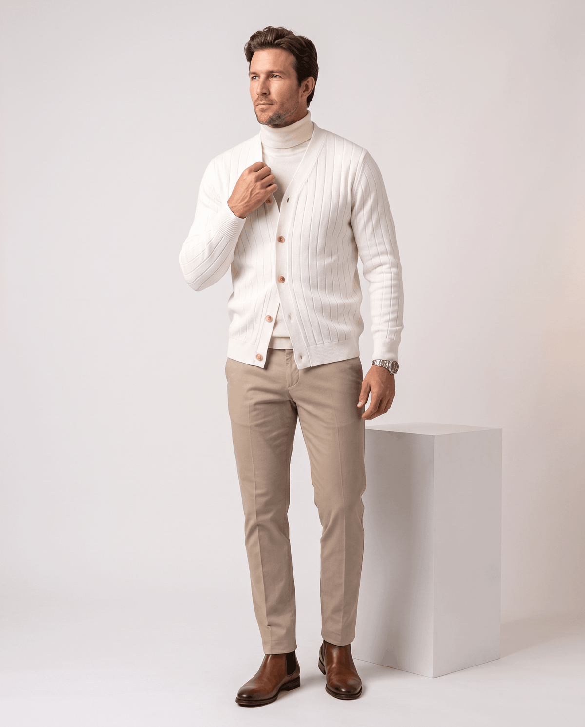 Full-length view of the white ribbed cardigan over a white turtleneck