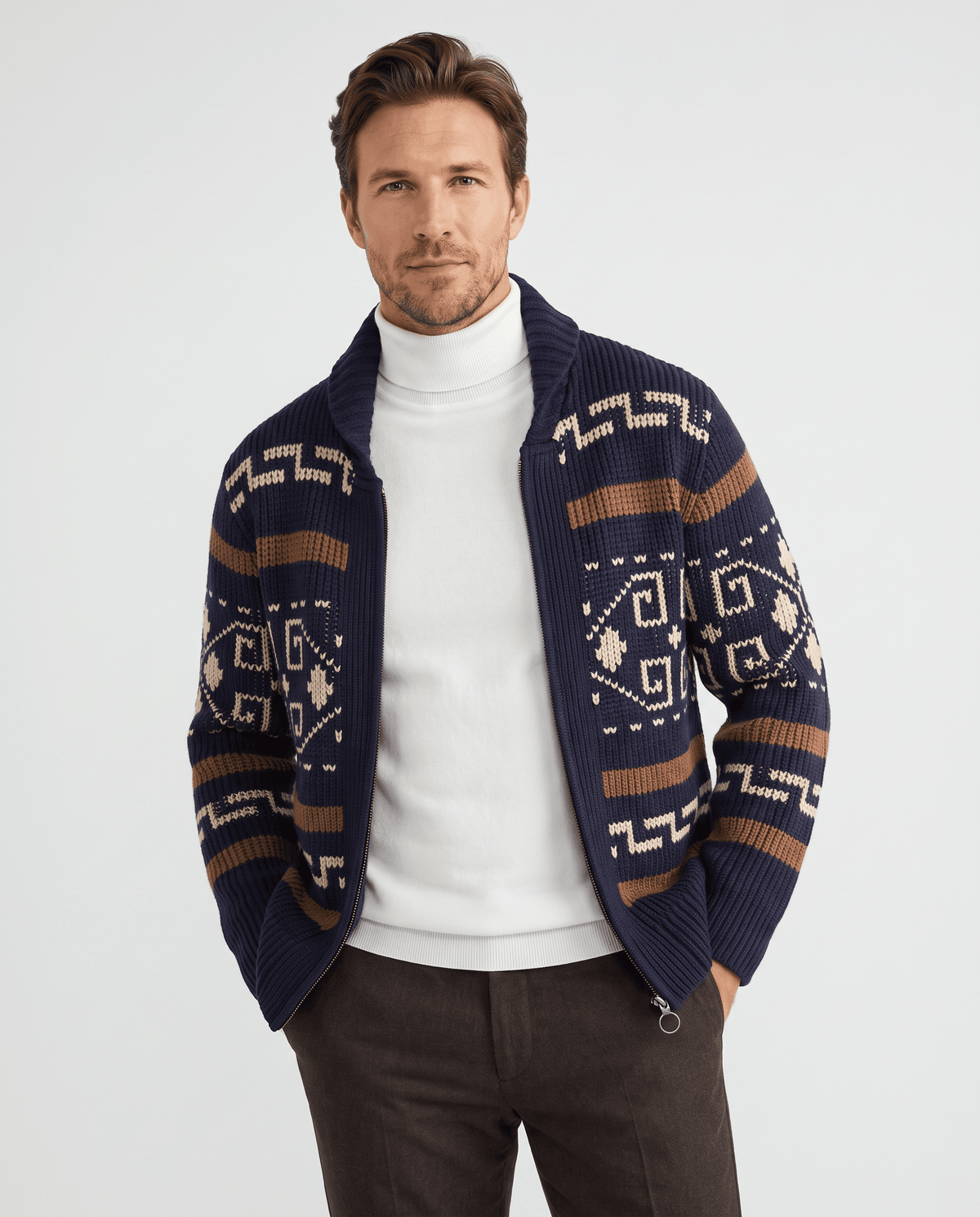Men's navy blue geometric jacquard zip cardigan with shawl collar worn over a white turtleneck