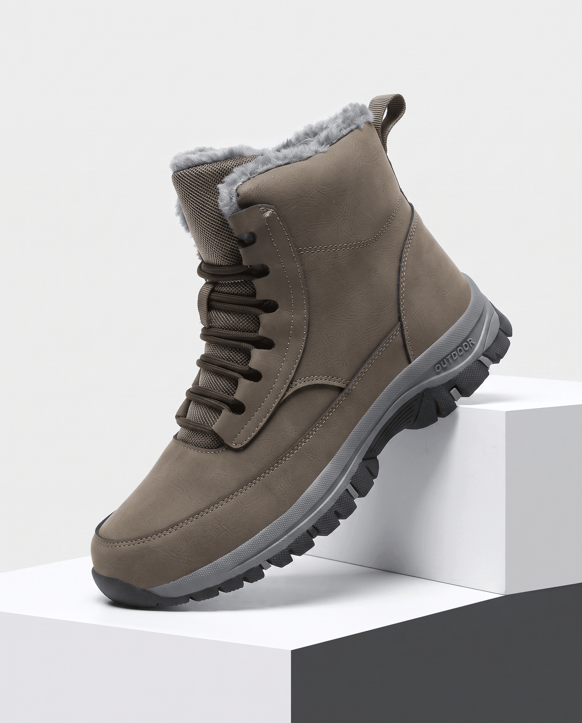 Khaki sherpa-lined lace-up winter boot with a padded tongue and rugged lug sole displayed on white blocks.