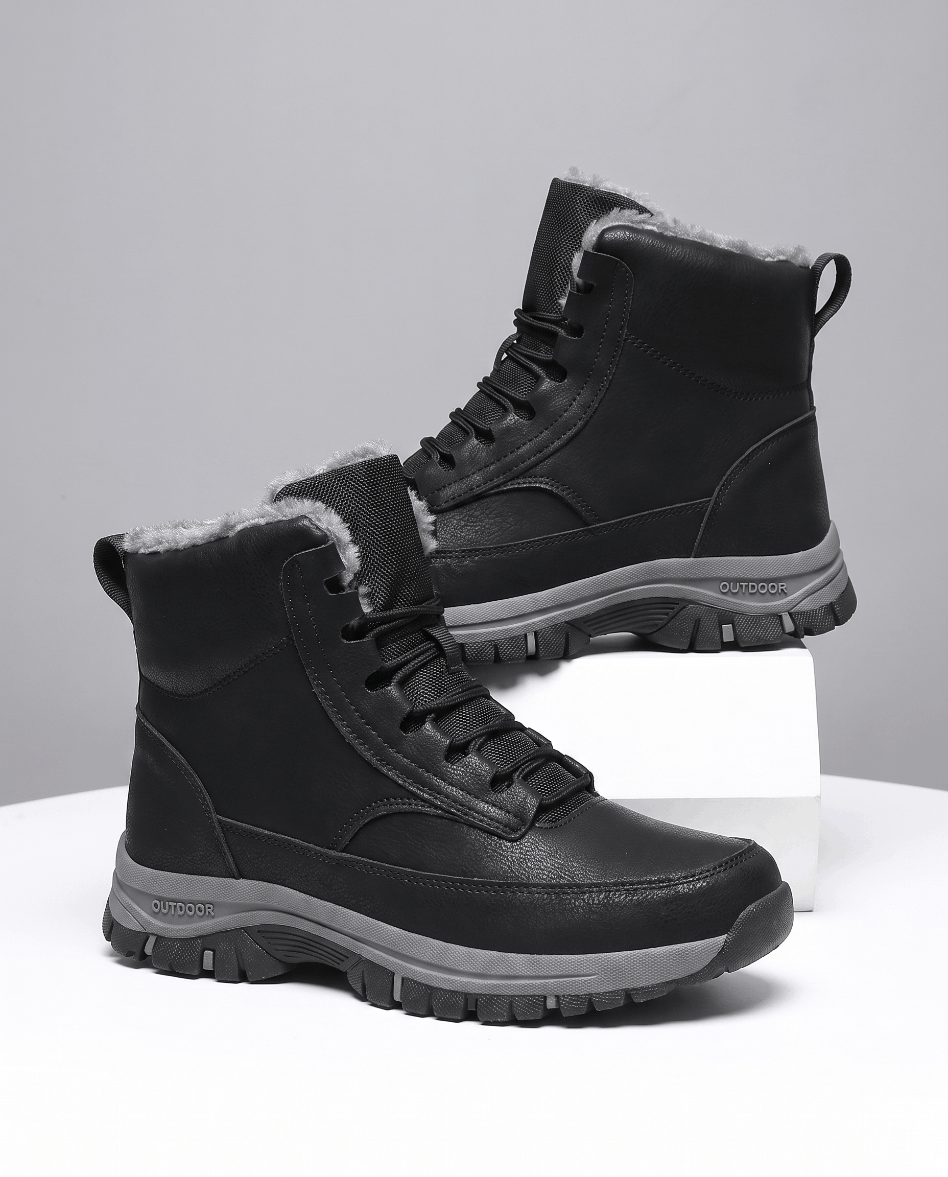 Pair of black insulated winter boots displayed on a neutral background.