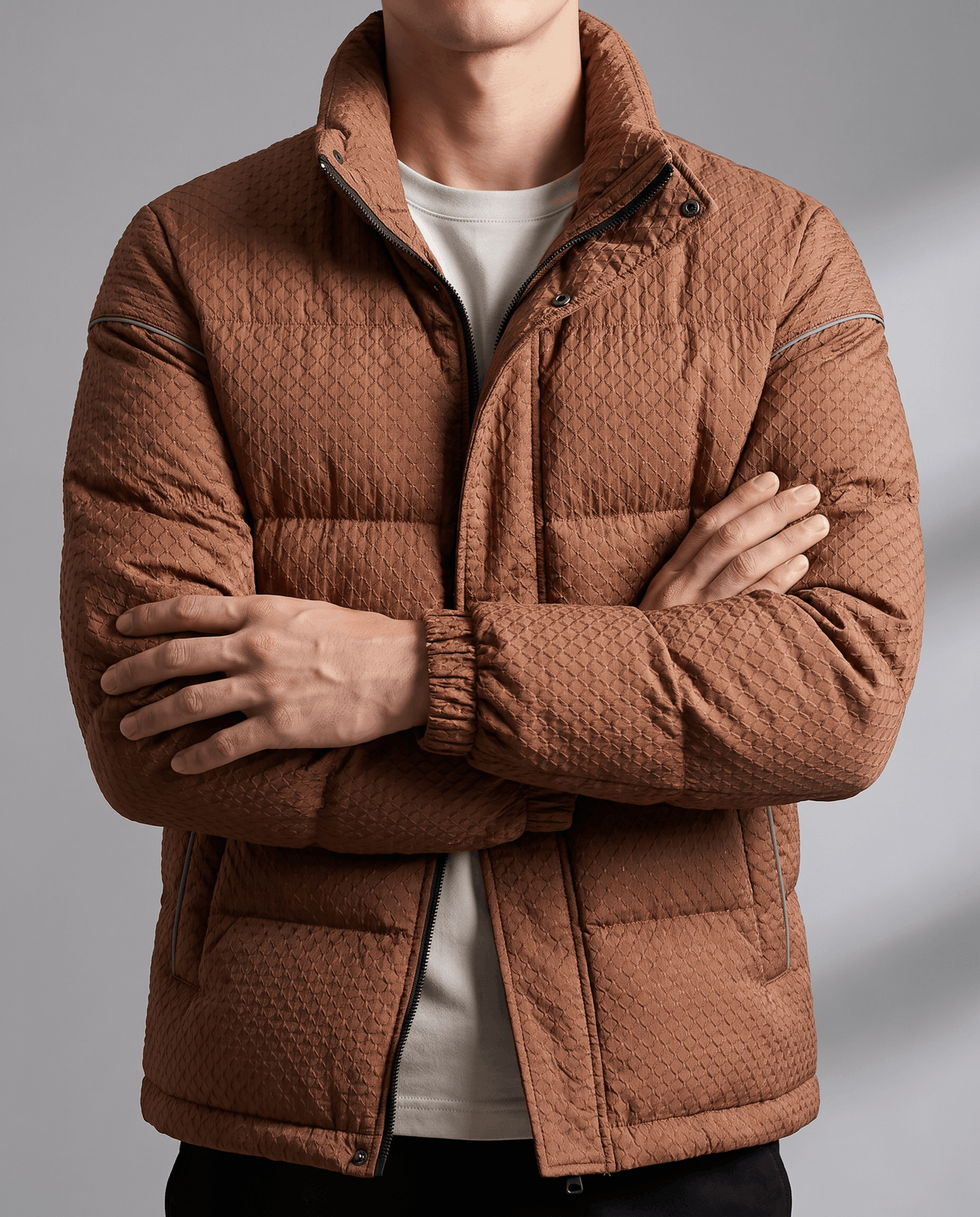 Chest detail of a caramel brown puffer showing padded channels and snap placket