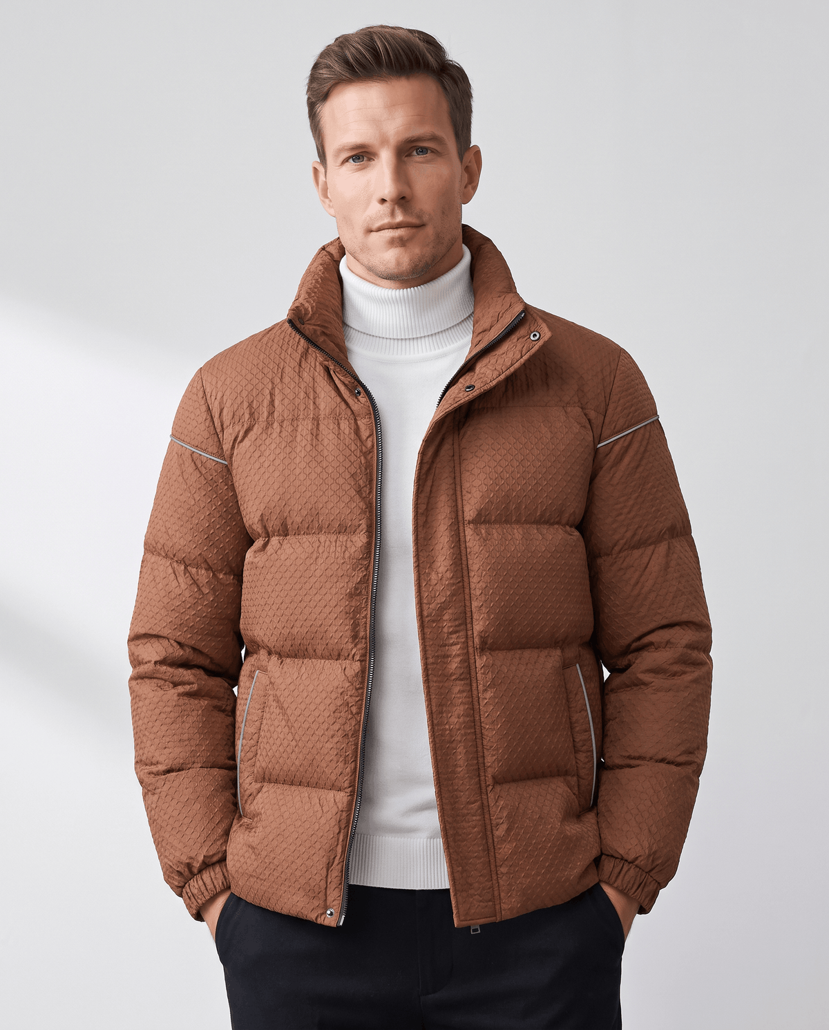 Caramel brown short puffer jacket on a model with stand collar and zip front