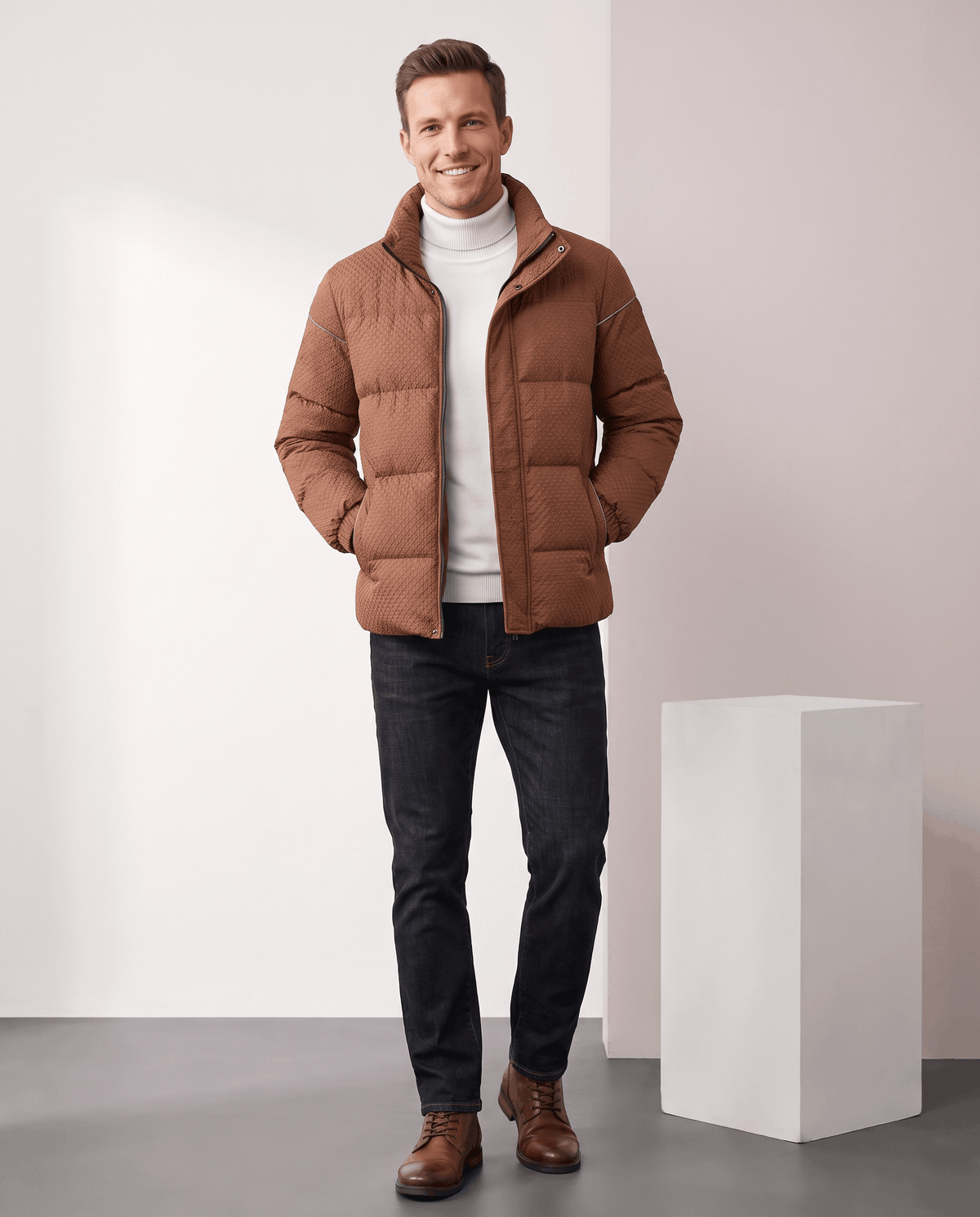 Full-length shot of a caramel brown puffer styled with dark jeans and brown boots