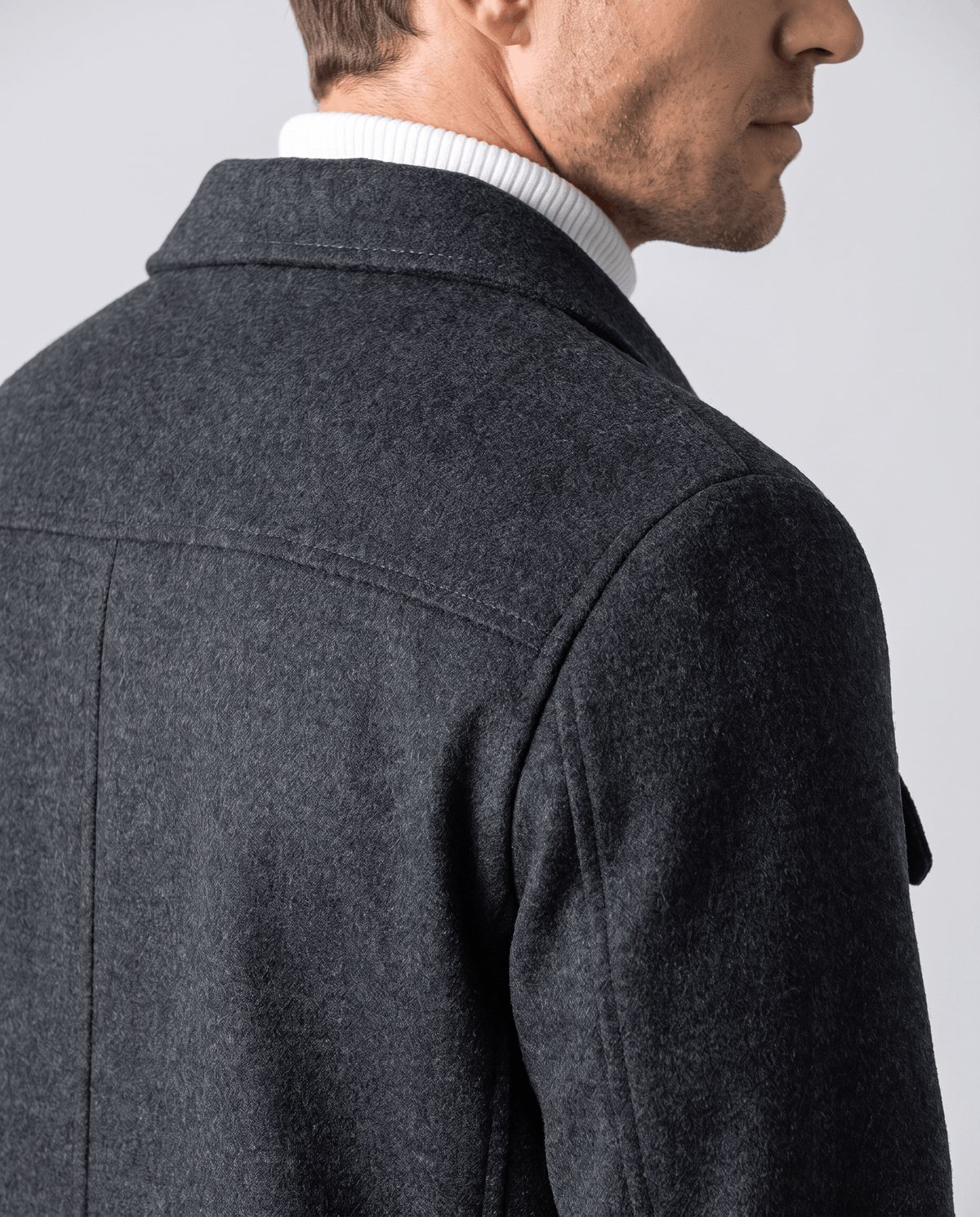Three-quarter rear view showing the shoulder seam and a side pocket opening