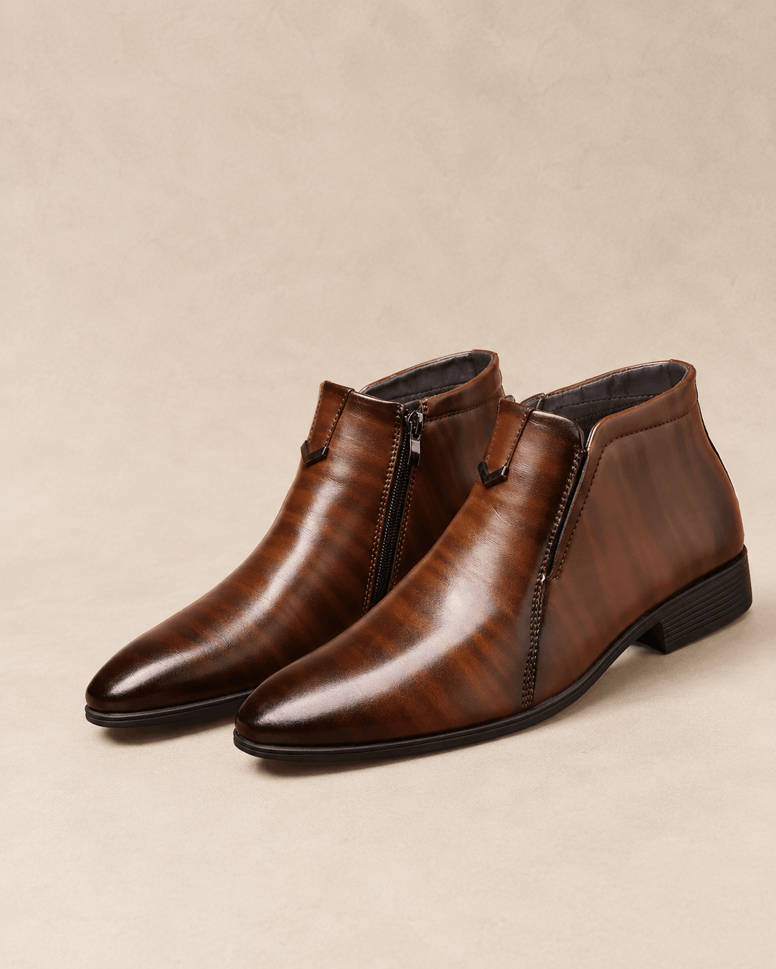 Brown polished grain leather ankle boots with a pointed toe, side zip closure, and notched topline on a block heel.