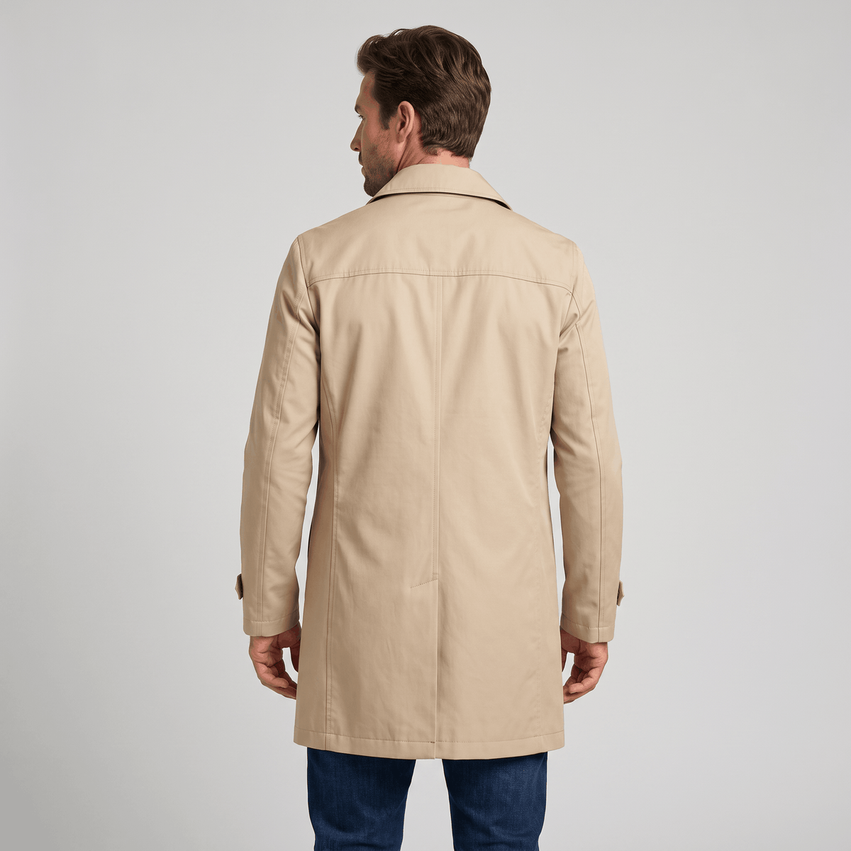 Back view of a beige men's trench coat.