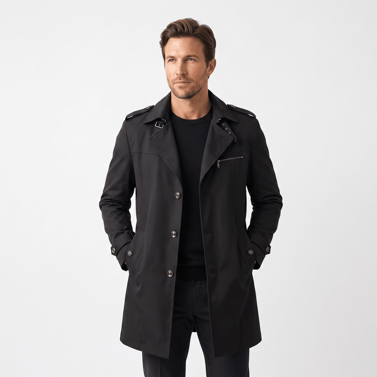 Man wearing a black trench coat with front pockets.