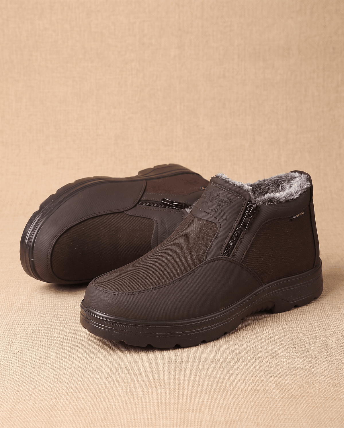 Pair of brown fleece-lined ankle boots displayed against a beige background.
