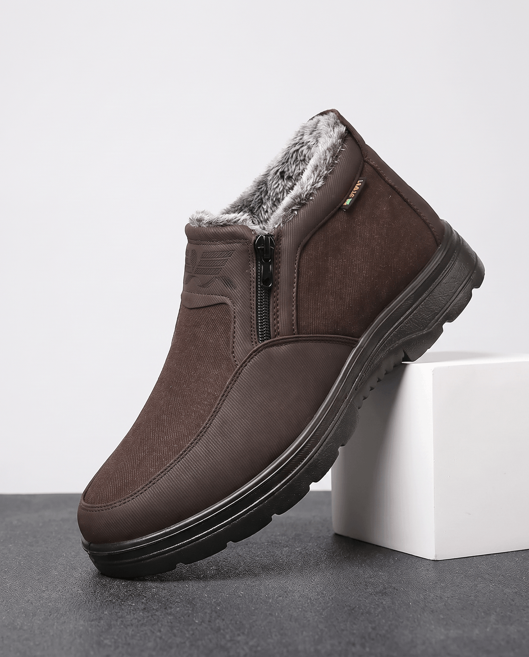 Brown fleece-lined ankle boot shown on a white pedestal.