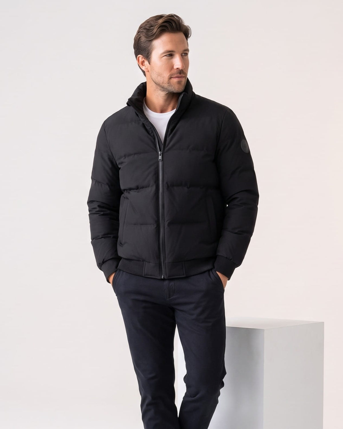Black colorway worn zipped with hands in pockets, collar standing upright