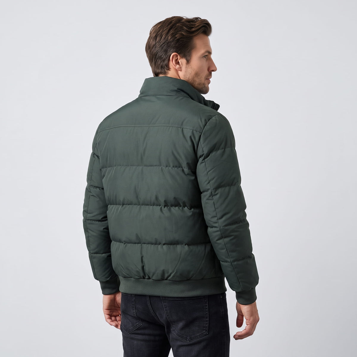 Back view in dark green showing the ribbed hem and boxy quilted blocks