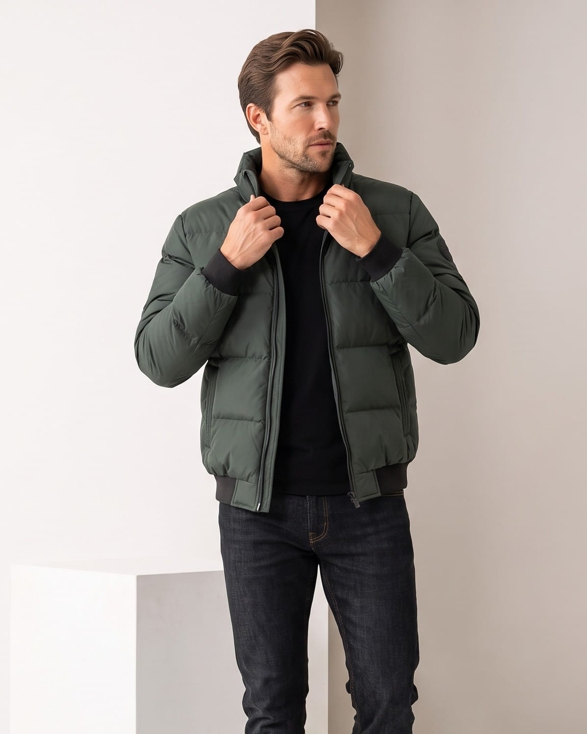 Dark green colorway worn open, hands lifting the stand collar at the neck