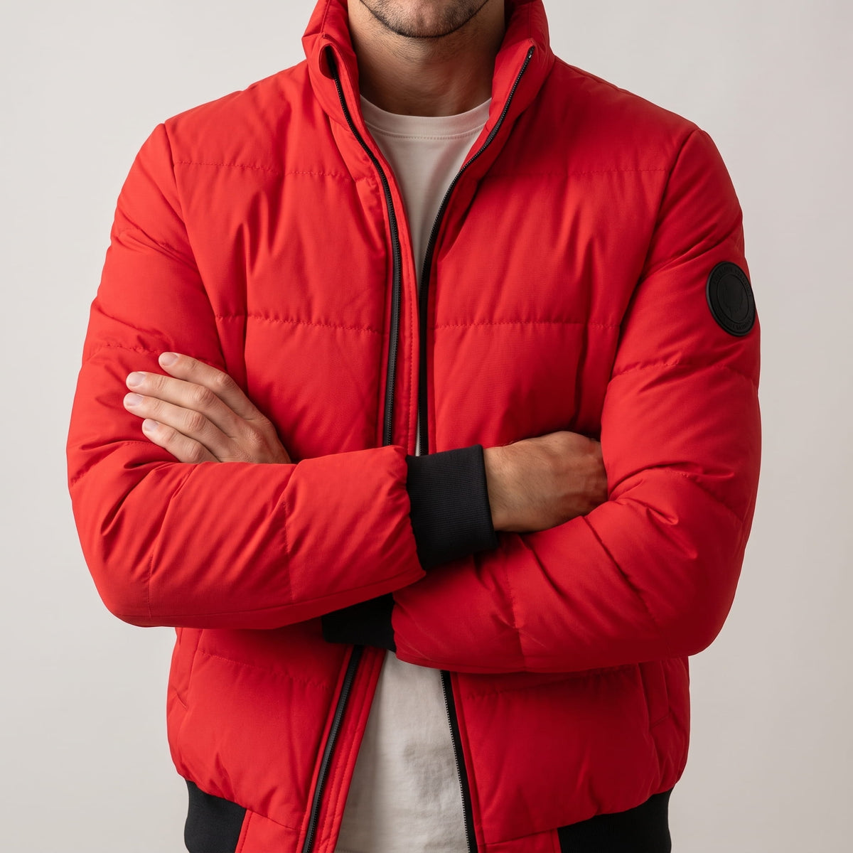 Red jacket torso with arms crossed, showing the full-length contrast zip