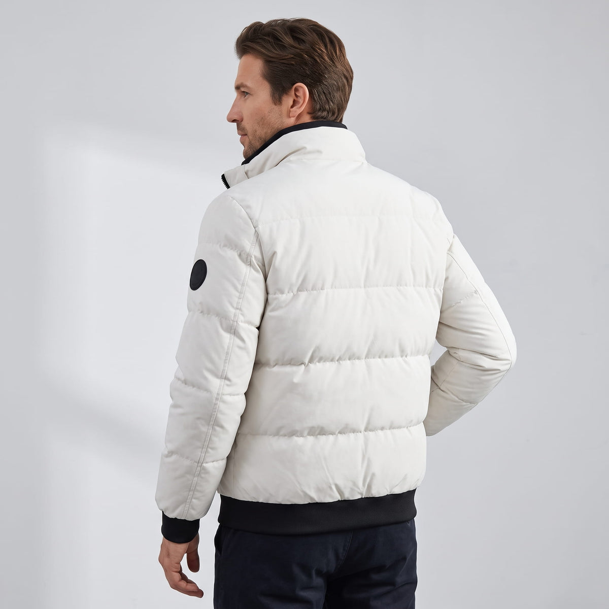 Back view in white showing horizontal quilted blocks and the ribbed hem